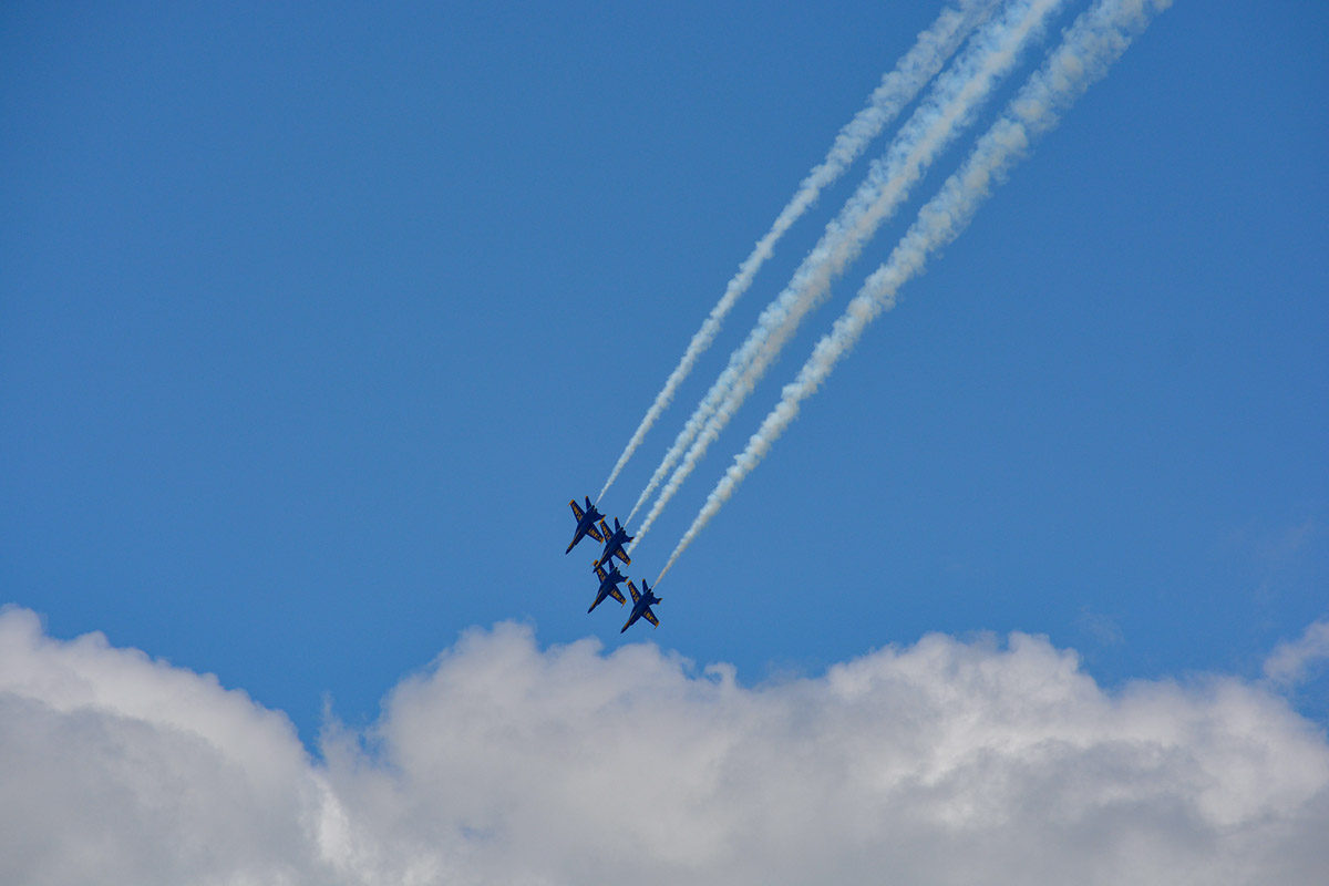 Jets dropping into a white puffy cloud