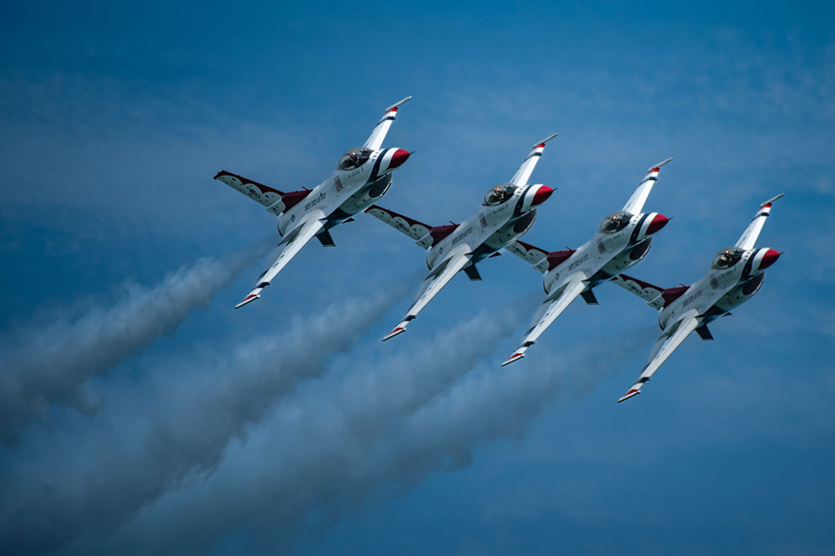 4 jets in tight formation, smoke trailing 