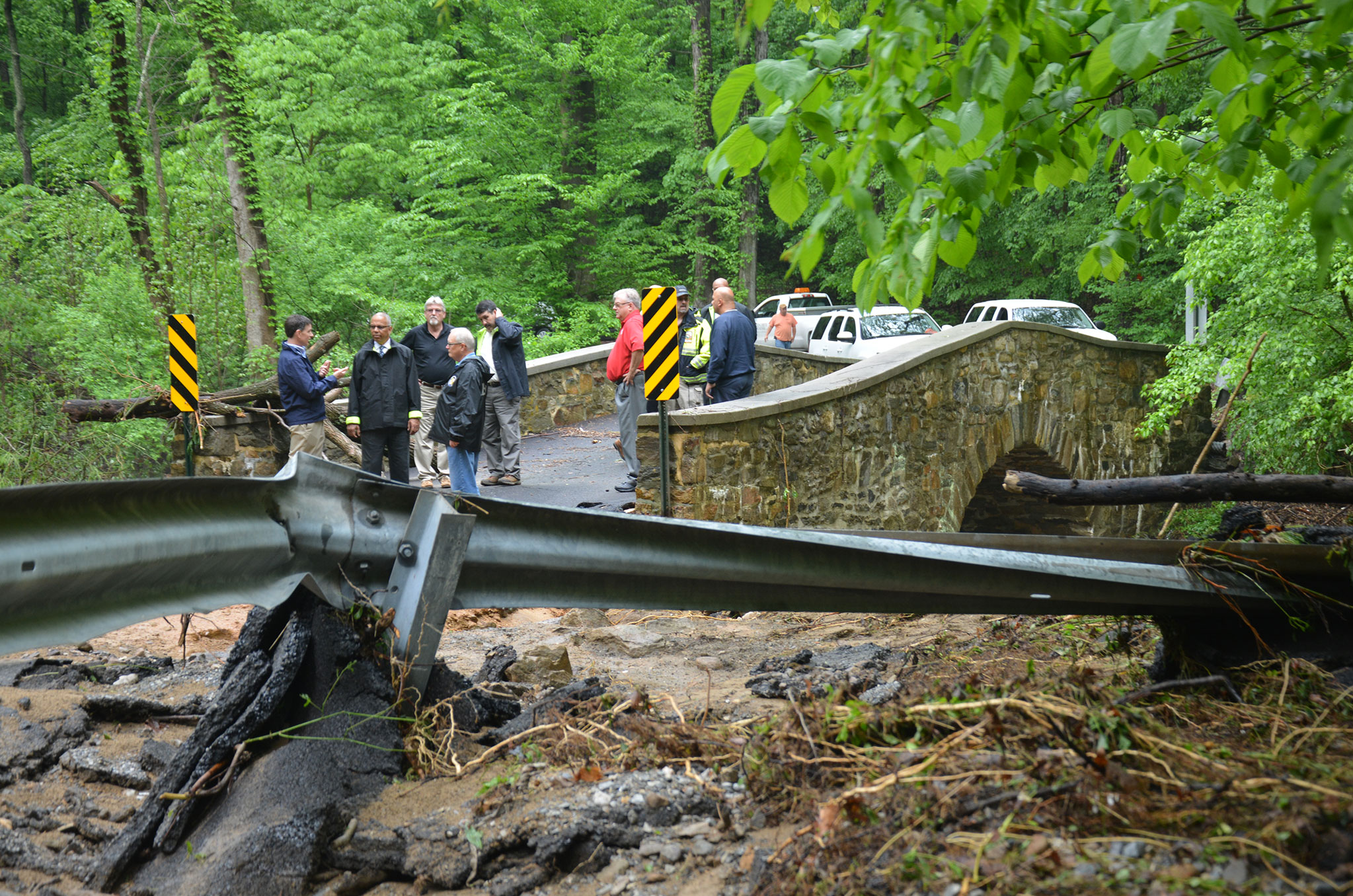 Lt. Governor looks over a washed out bridge